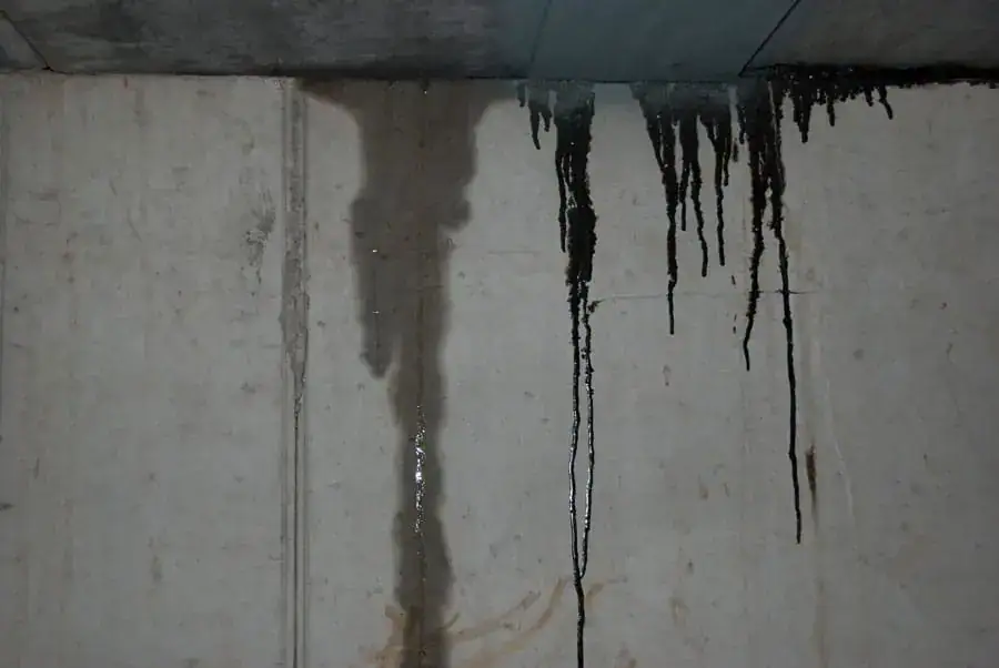 Water leaking down concrete wall