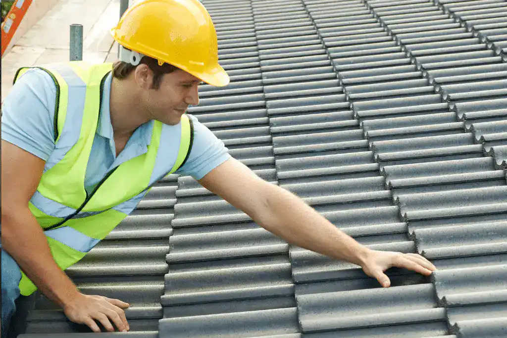 Roofing contractor inspecting a residential roof in Toronto during the spring to check for winter damage.