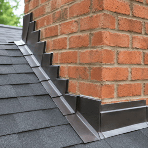 Close-up of chimney step flashing and counter flashing around brick masonry