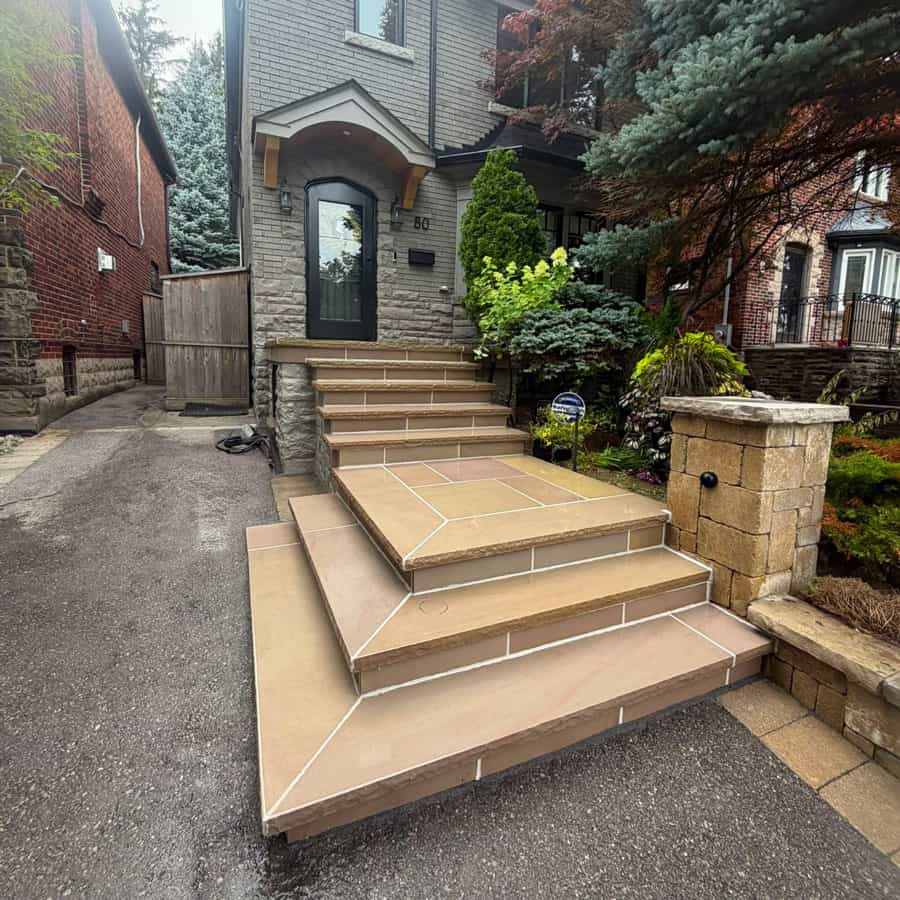 Beautiful stone masonry steps leading to a modern home entrance.