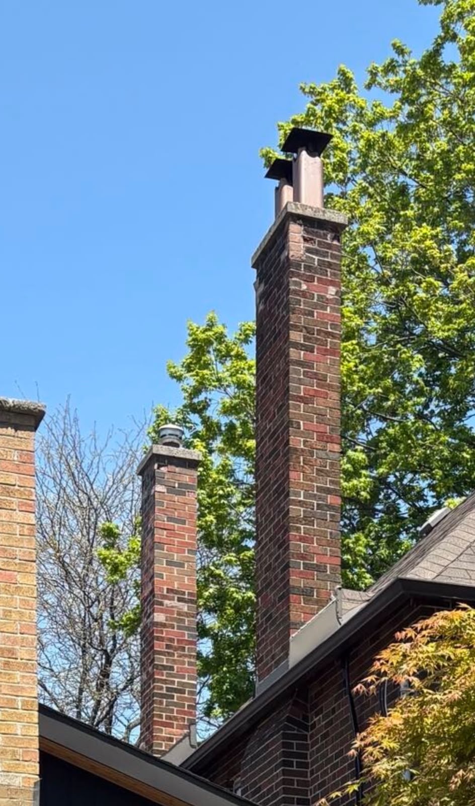 Two brick chimneys before rebuilding near Jane Street and Annette Street in West Toronto