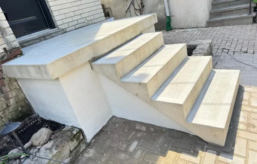 Modern concrete stairs with clean lines and smooth finish by A & A Masonry.