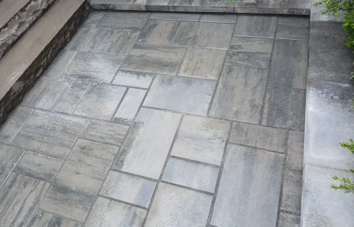 Stone patio with interlocking concrete pavers for outdoor space.