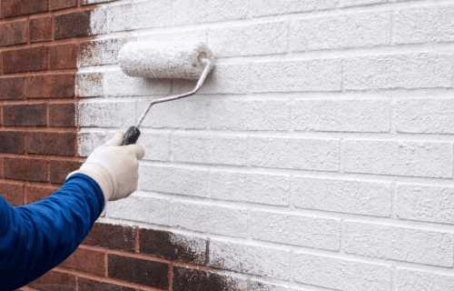 Crew applying SurGuard masonry coating to a Grimsby commercial brick wall