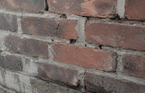 Damaged brick and mortar that should be repaired before sealing