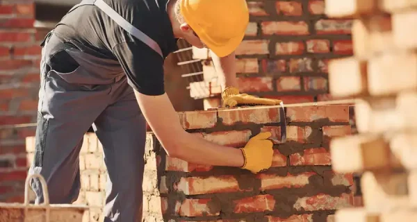 laying brick wall