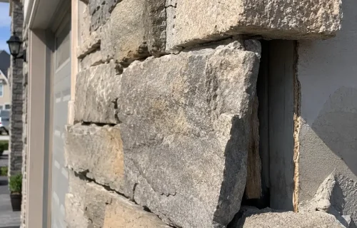 Loose stone veneer pulling away from an exterior wall